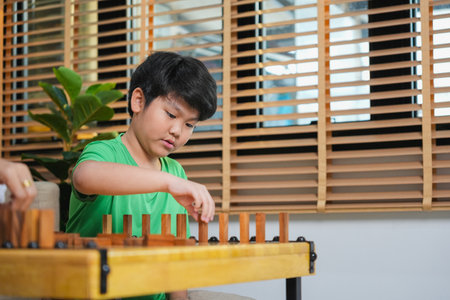 Close up of Boy PlayingBlock Game at Home, Mother and Son Playing Block Game in Living Room, Parent and Child Enjoying Quality Time Togetherの写真素材