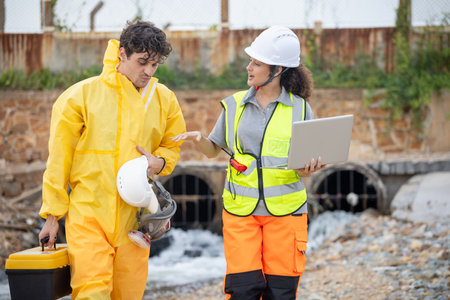 Environmental Scientists Testing Polluted Water Near Industrial Drain, Workers Collecting Water...