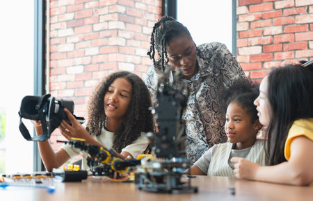 Girls Engaged in STEM Learning with Robotics and VR, Diverse Students and Teacher Exploring...