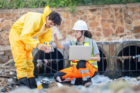 Workers Collecting Water Samples for Environmental Research, Engineers Analyzing Environmental Data on a Beach Cleanup Project, Environmental Workers Inspecting Industrial Siteの写真素材