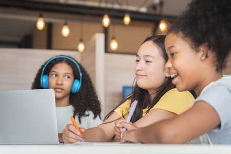 Diverse Group of Young Students Learning Together, Happy Girls Collaborating on a School Project,...