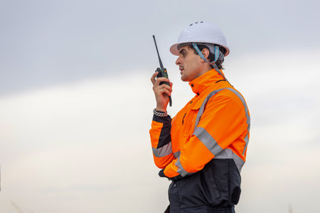 Maritime Safety Engineer Working at Port Terminal with Walkie Talkie, Dock Worker in Safety Uniforms...
