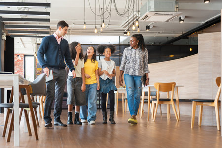 Diverse Group of Kids and Adults Walking Through a Modern Office Space, Mentors Guiding Young...