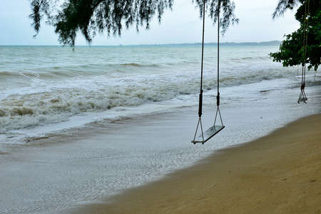 Alone Swing at the beach during heavy raining.の写真素材