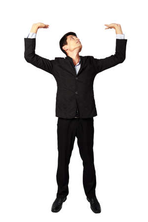 Handsome businessman in suit his arms up with heavy concept on white background 
の写真素材