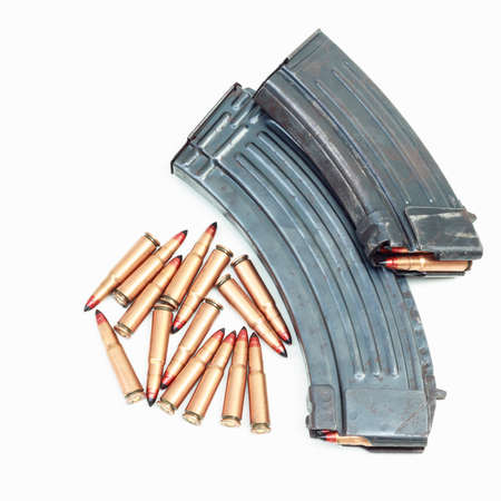 rifle bullet and ammunition pouch on white background