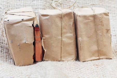 rifle bullet in old wrapping paper, a packaging factory ammunition.の写真素材