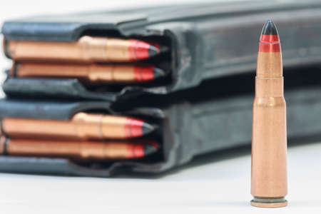 rifle bullet and ammunition pouch on white background:Choose a focal point ammunition.の写真素材