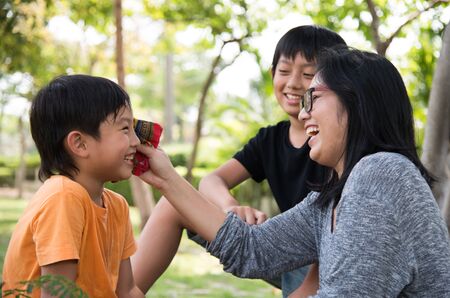asian family take care happy cute park mother sonの写真素材