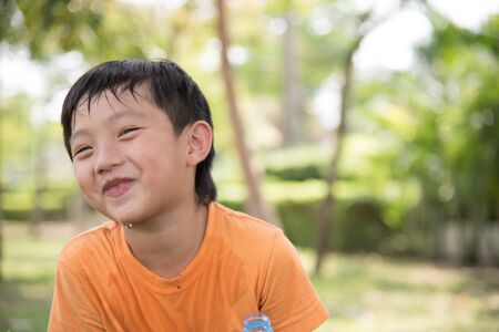 asian boy drink water park nature drinking happy smileの写真素材