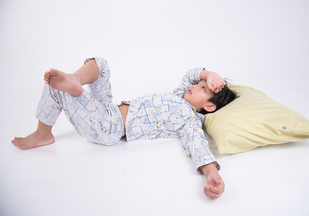 asian boy worry worried sleep sleepless bed tired thinking foreheadの写真素材