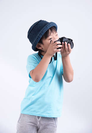 Asian kids with camera on white backgroundの写真素材