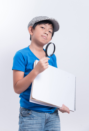 asian boy detective magnifier lens note paper blank curiosityの写真素材
