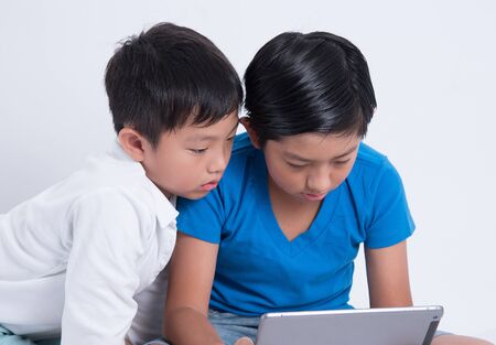 asian boy play tablet digital technology kidの写真素材