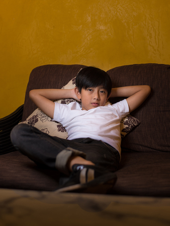 asian boy kid home siitting sofa portrait smart cute coolの写真素材