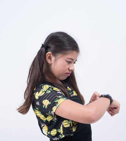 asian girl waiting watch time looking late checking hand wristwatch delayの写真素材