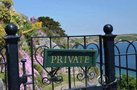 Private sign attached to a ornate garden gate,の写真素材