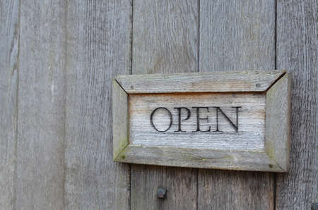 Open sign on wood door.の写真素材