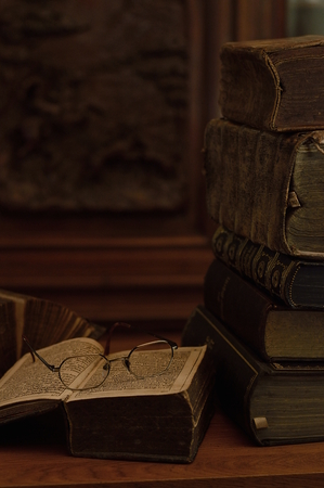 antique books with reading glassesの写真素材