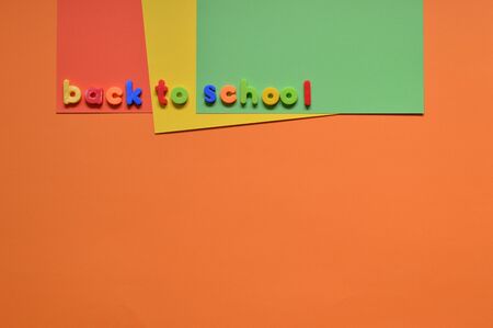 BACK TO SCHOOL with letters on colorful paper boardの写真素材