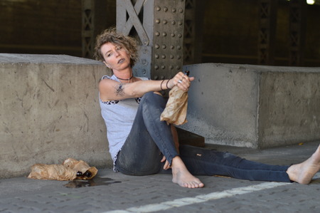 A punk woman drinking a cup of coffee in her hand