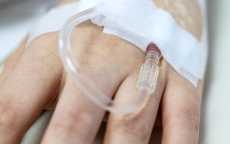 female hand with IV solution in a patients   handの写真素材