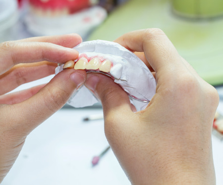 Woman hand Make denture with tool