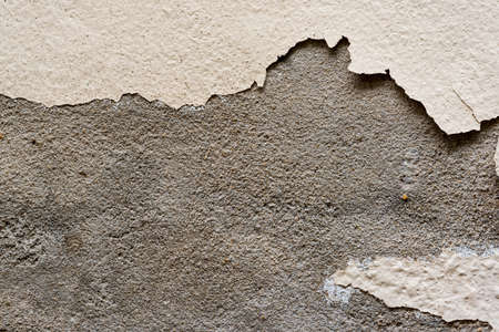 grunge old yellow paint cement wallの写真素材
