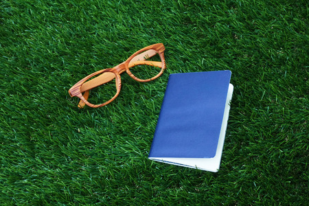 passport andd glass on grassの写真素材