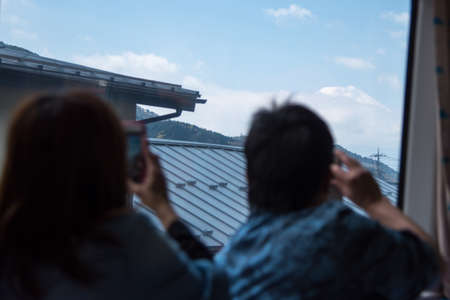 On the train , t tourists take photo Mt.Fujiの写真素材