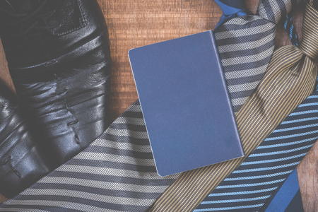 Necktie and shoes,passport on grunge wood backgroundの写真素材