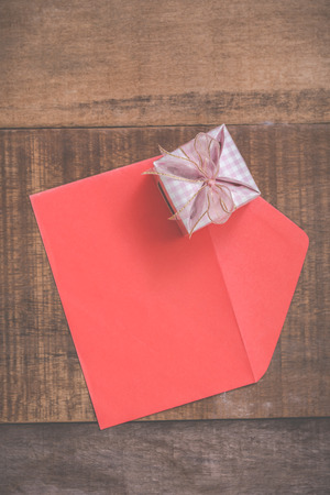 gift box and red envelope on wooden backgroundの写真素材