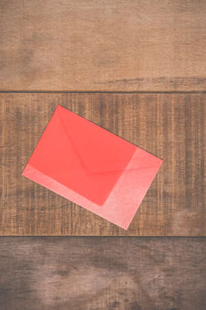 Grunge red envelope on wooden background