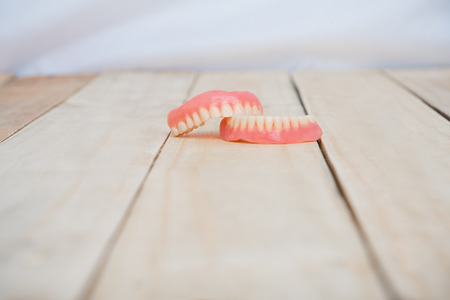 Dentures on wooden tableの写真素材