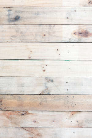 Grunge brown wood  wall background with knots and nail holesの写真素材
