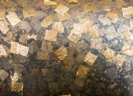 Texture of the gold leaf cover on buddha statue in temple, Thailandの写真素材