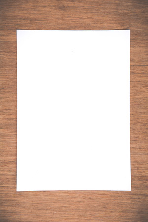 Close up White notebook paper on grunge wood backgroundの写真素材