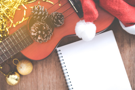 View from above Christmas background with pine corns and ukulele on wooden backgroundの写真素材
