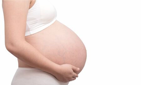 The belly asia pregnant woman isolate on white backgroundの写真素材