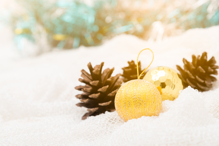 Christmas decoration and pine cones against lights blur balckgroundの写真素材