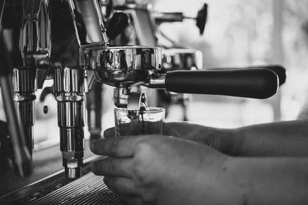 Hands using coffee machine in coffee shoppの写真素材