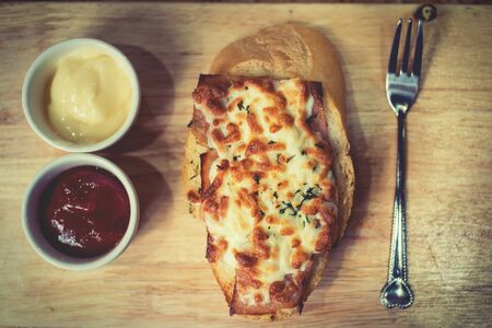Bread baked with cheese served with tomato sauce chili sauce and delicious recipes.food topviewの写真素材