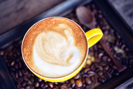 coffee mocha hot and coffee beans on wooden table on wooden backgroundの写真素材