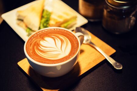 coffee mocha hot on wooden table on brown backgroundの写真素材