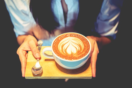 woman holding coffee mocha hot on wooden background