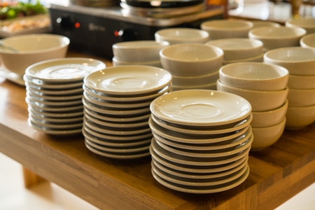 Cups and utensils arranged on a white table and buffet breakfast.の写真素材
