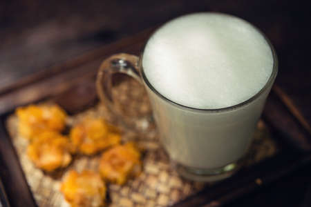 Hot milk in a glass on Nature wooden Backgrounds,Vintage Style.の写真素材