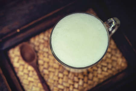 Hot milk in a glass on Nature wooden Backgrounds,Vintage Style.の写真素材