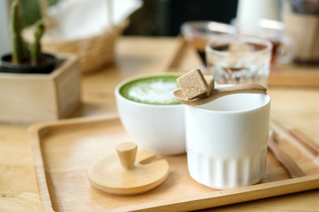 Hot green tea set on a wooden table in a coffeshop