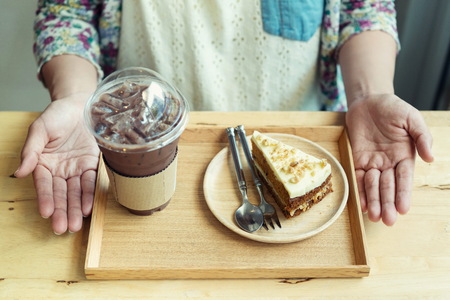 Woman holding Ice coffee and Coffee  in a coffee shop in holidaysの写真素材